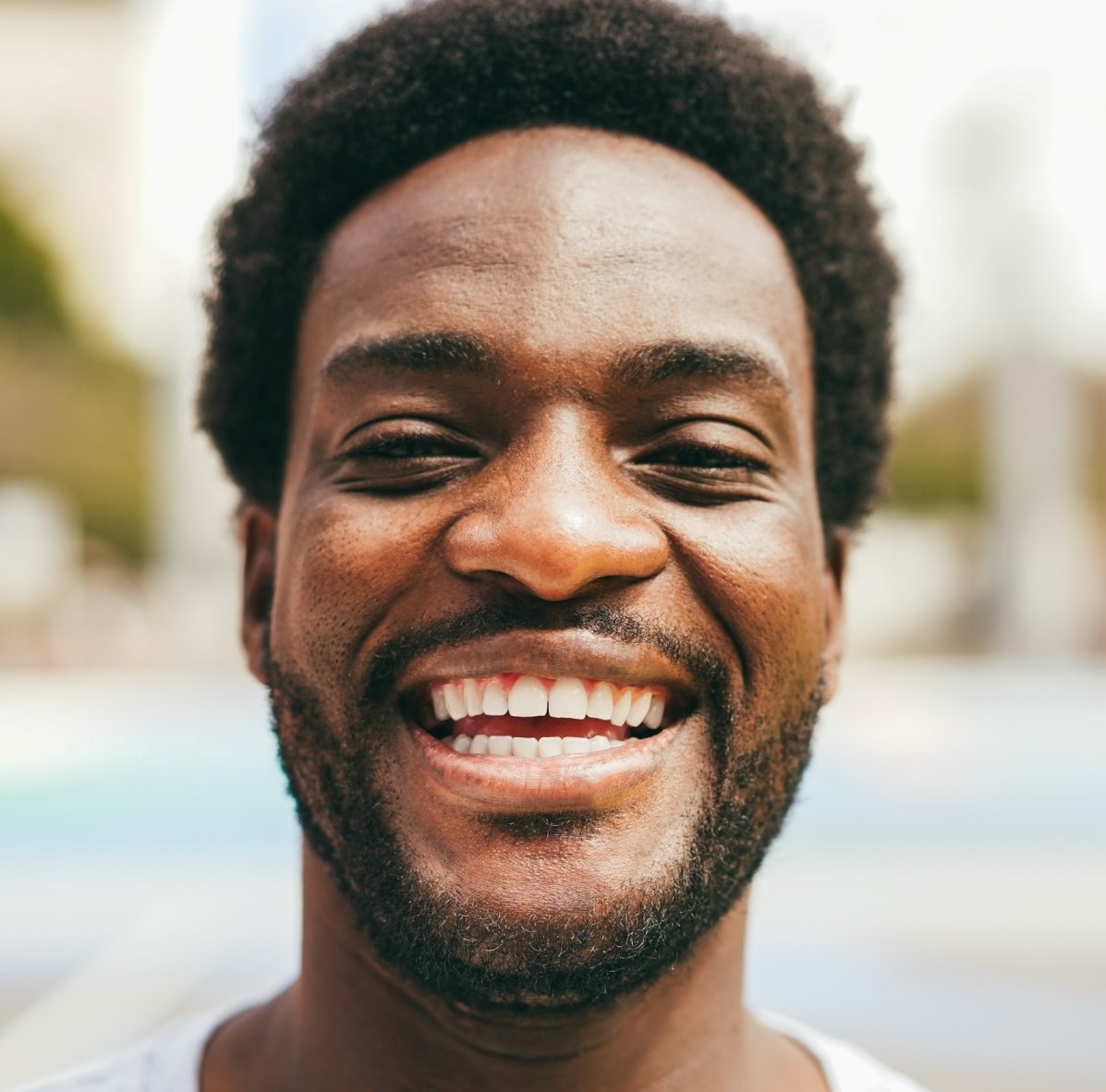 happy african man smiling at camera inside ba 1