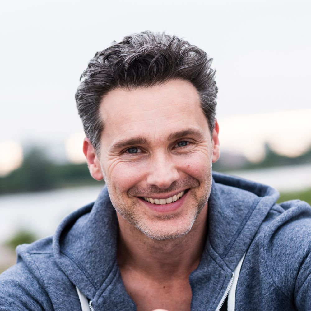 portrait of smiling man at the riverside B6W5EHB 1 2 1