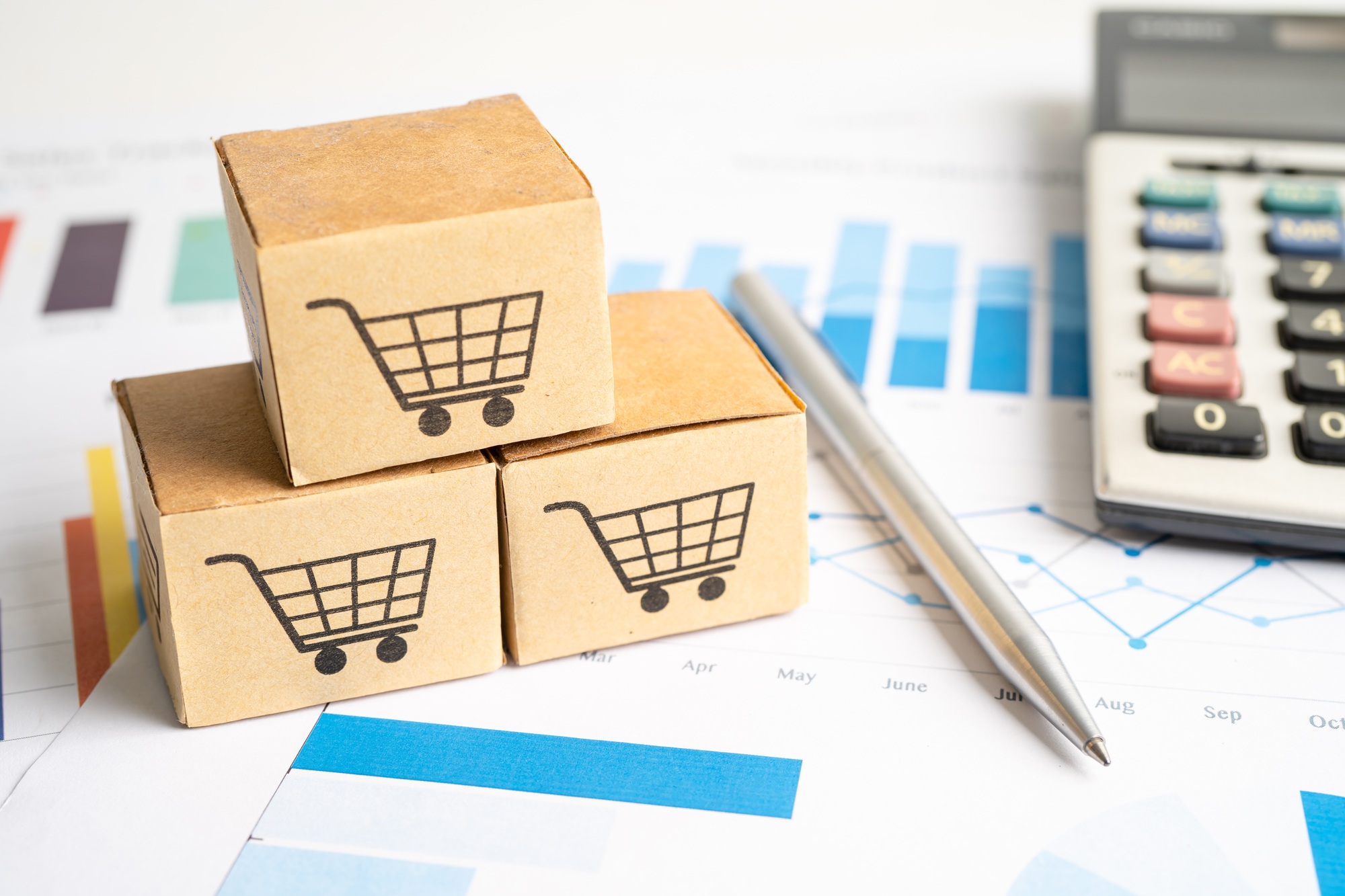 Shopping cart logo on box on graph background.